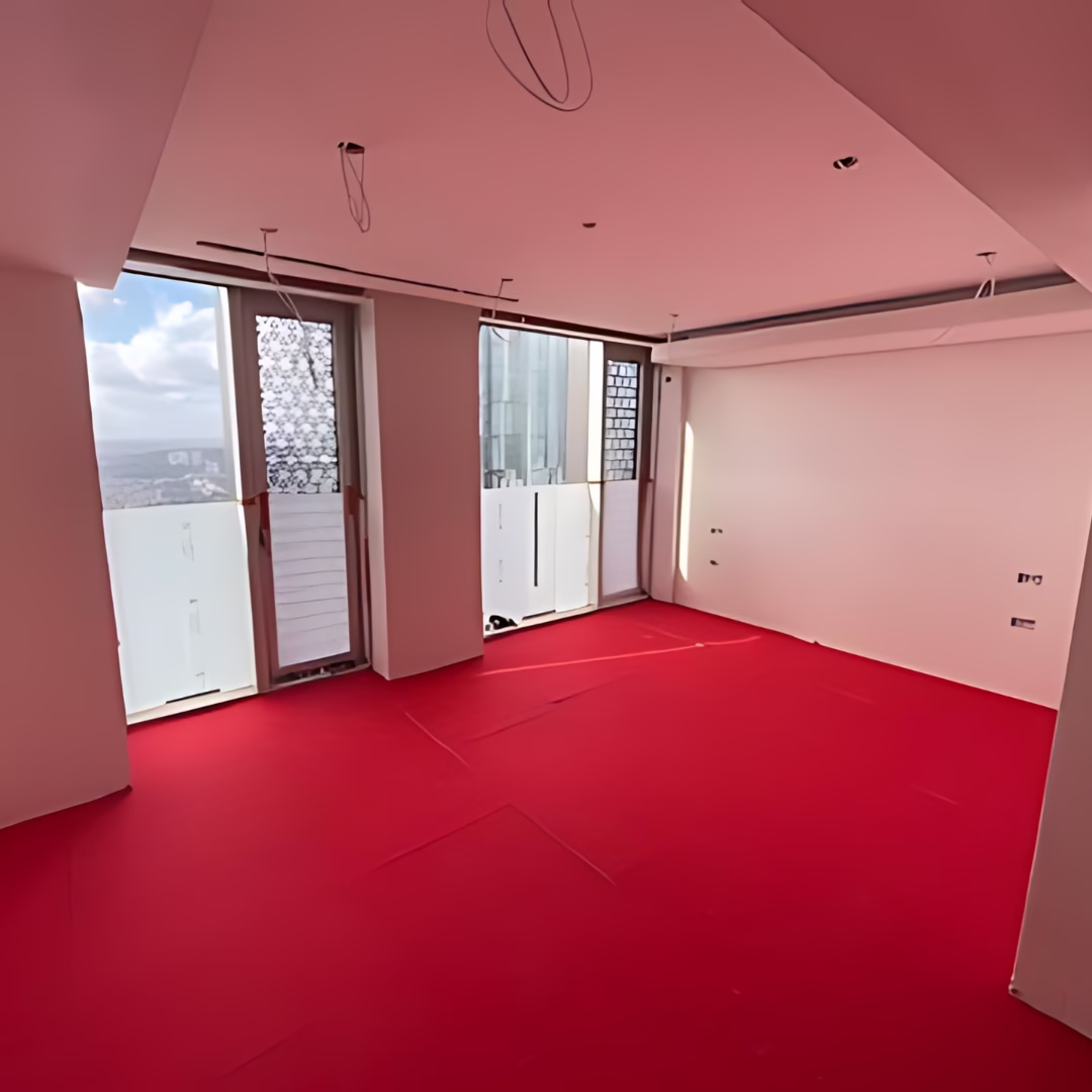 Underfloor heating installation in a luxury smart home showing hidden infrastructure beneath the floor before finishes are applied.